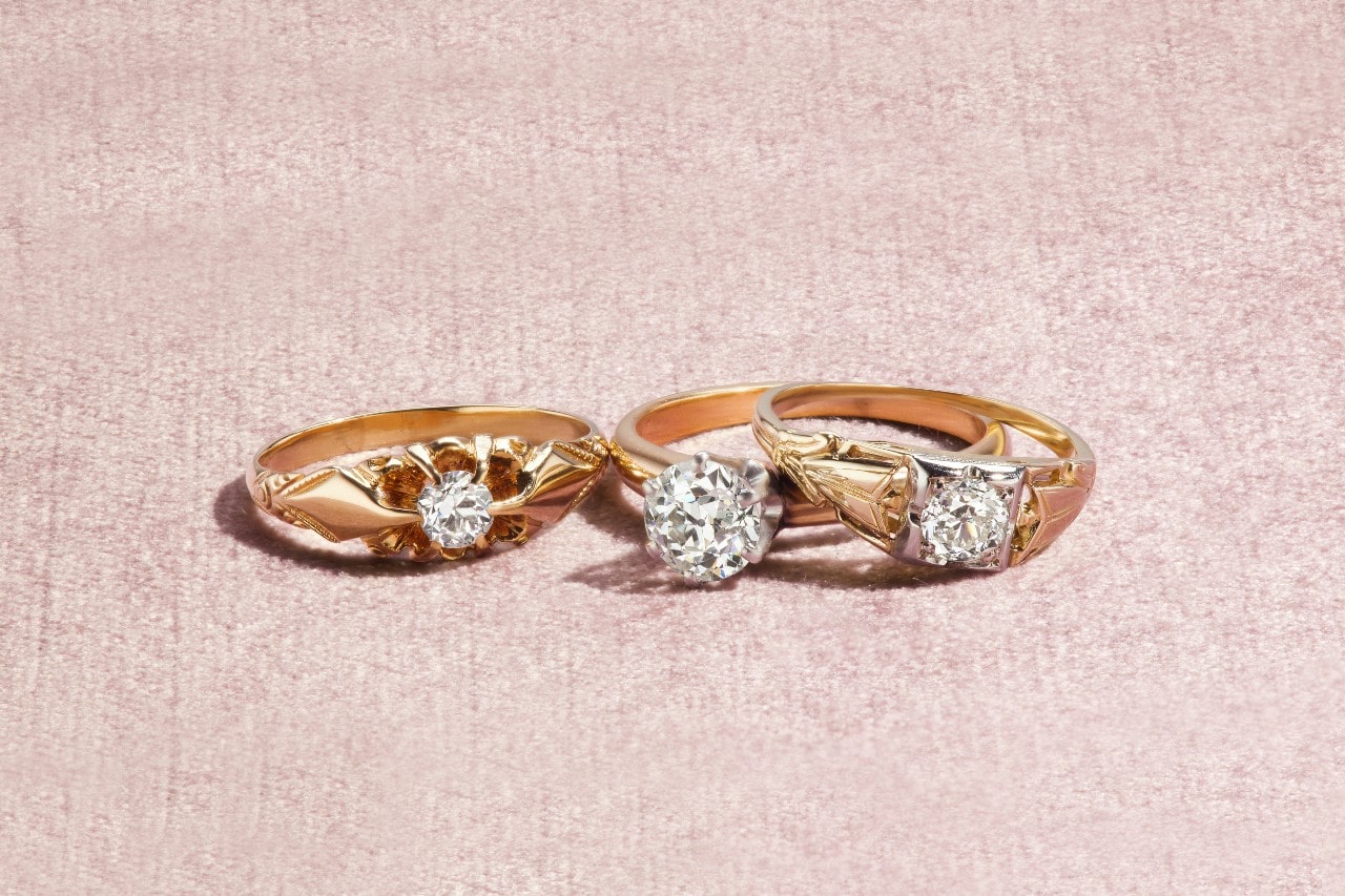 three yellow gold diamond engagement rings with unique settings