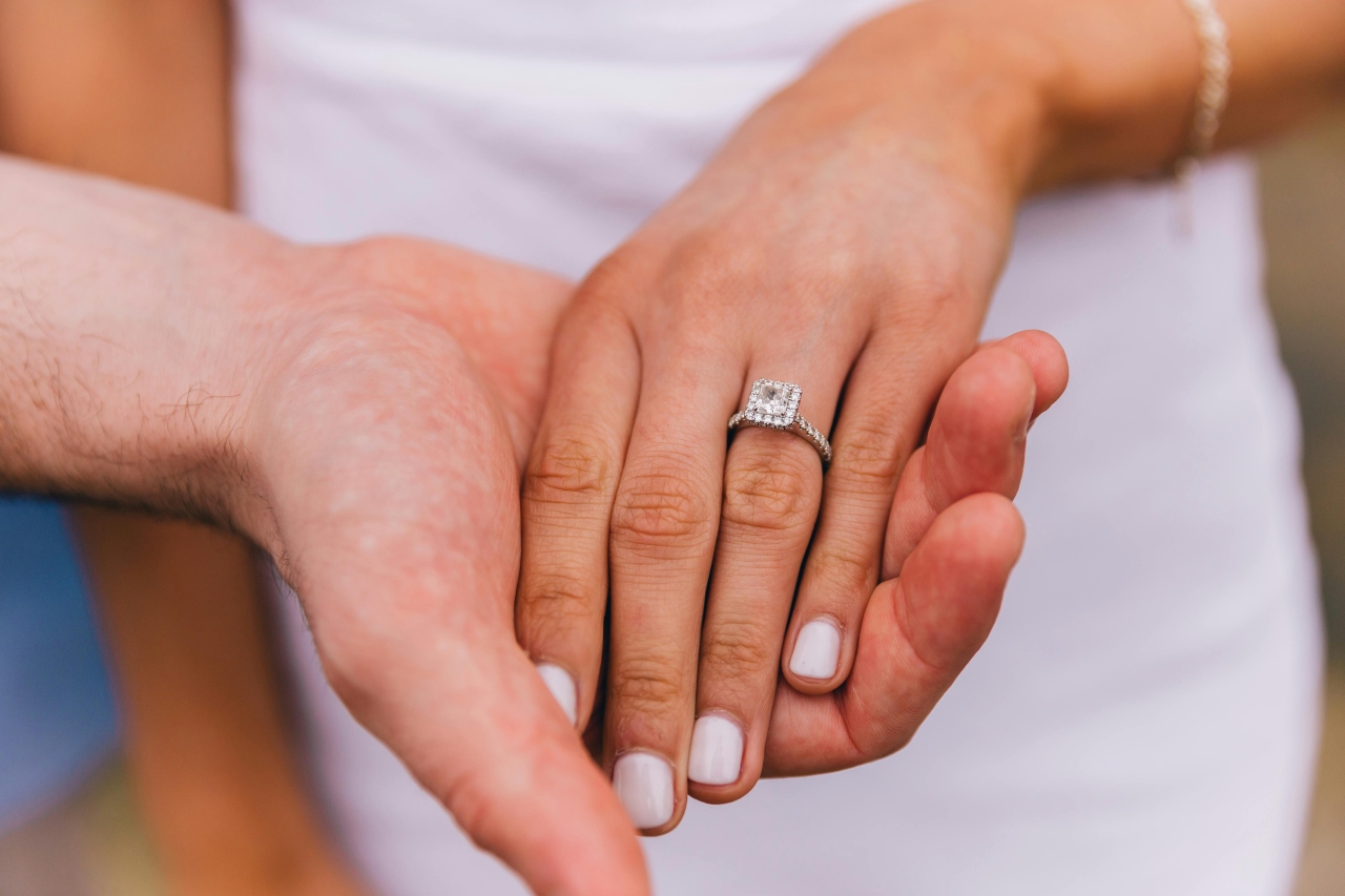 View of a woman’s halo diamond ring