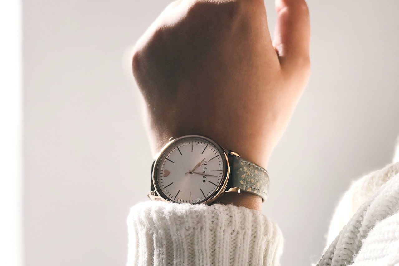 A close-up of a woman’s wrist, adorned with a simple watch.