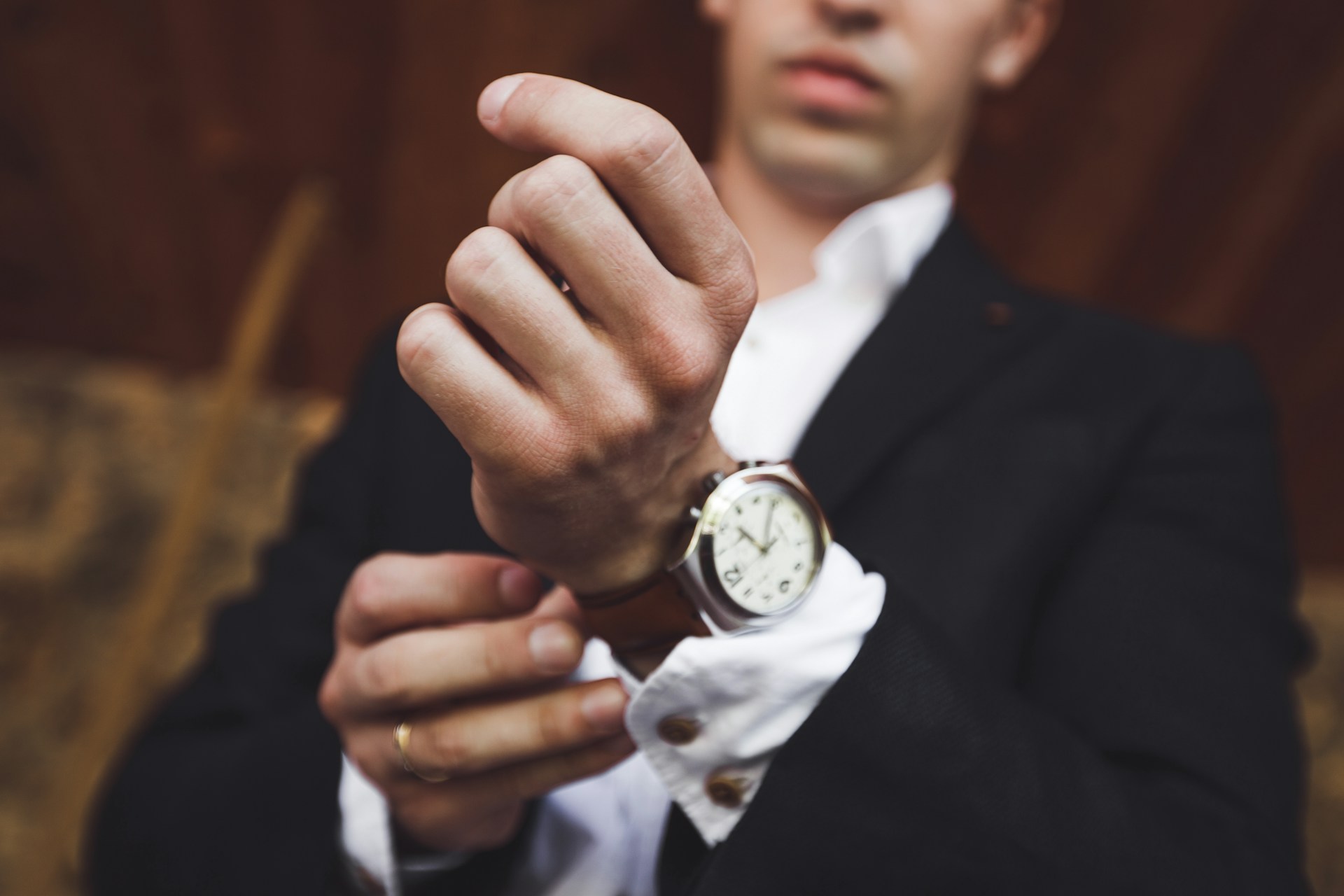 a man wearing a suit and a luxury watch