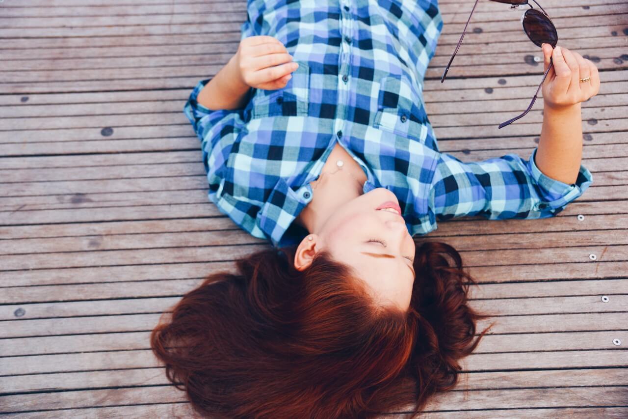 lady laying down on dock with diamond necklace 