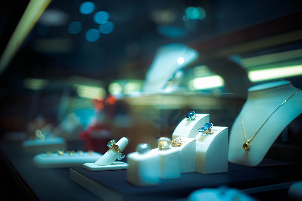 An elegant view of a jewelry store showroom in low light.